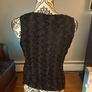 Black sleeveless shirt, with silver thread embroidery.